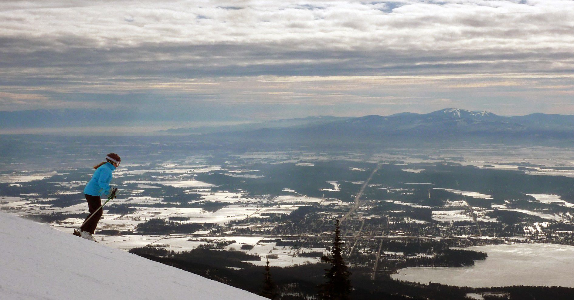 A skier makes her way down from the summit